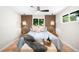 Stylishly decorated bedroom featuring wood accent wall, ceiling fan, and inviting decor at 6512 Upham St, Arvada, CO 80003