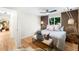 Comfortable bedroom with wood accent wall, stylish lighting, and a cozy decorative bench at 6512 Upham St, Arvada, CO 80003