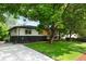 The exterior of the home is nicely landscaped, and features a driveway with a covered porch entry at 6512 Upham St, Arvada, CO 80003