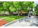 Well-maintained home with lush lawn, mature trees, and an inviting covered front porch at 6512 Upham St, Arvada, CO 80003