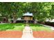 This inviting single-story home features mature shade trees and an inviting covered front porch at 6512 Upham St, Arvada, CO 80003
