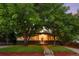 The attractive single-story home has mature trees and nice landscaping that complements the exterior at 6512 Upham St, Arvada, CO 80003