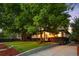 Charming home with mature trees, green grass, and attractive landscaping at 6512 Upham St, Arvada, CO 80003