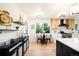 Kitchen with stainless steel appliances, breakfast table, custom backsplash, and decorative lighting at 6512 Upham St, Arvada, CO 80003