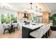 Updated kitchen featuring a large island with white quartz countertops and stylish chandelier lighting at 6512 Upham St, Arvada, CO 80003