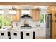 Well-lit kitchen with an island, stainless steel appliances, and a custom tile backsplash at 6512 Upham St, Arvada, CO 80003