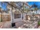 Cozy back patio with stone pavers, enclosed by a wooden fence for privacy and shaded by a tree at 1354 Carlyle Park Cir, Highlands Ranch, CO 80129