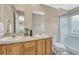 Bathroom featuring a double sink vanity and shower with glass door at 1354 Carlyle Park Cir, Highlands Ranch, CO 80129