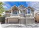 Multi-level home with a three-car garage and a balcony at 1354 Carlyle Park Cir, Highlands Ranch, CO 80129