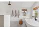 Bright bathroom with white subway tile, a soaking tub, and a walk-in shower at 3267 Stuart St, Denver, CO 80212