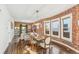 Dining area with exposed brick and farmhouse table at 3267 Stuart St, Denver, CO 80212