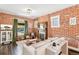 Living area with exposed brick wall and vintage fireplace at 3267 Stuart St, Denver, CO 80212