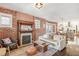 Living room features exposed brick, fireplace, and hardwood floors at 3267 Stuart St, Denver, CO 80212