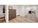Open finished basement area featuring wood laminate flooring and neutral walls with washer and dryer at 4650 S Laredo St, Aurora, CO 80015
