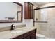 Modern bathroom featuring a glass enclosed shower, granite countertop and dark wood cabinets at 4650 S Laredo St, Aurora, CO 80015