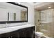 Elegant bathroom featuring a double vanity, large mirror, and glass enclosed shower at 4650 S Laredo St, Aurora, CO 80015
