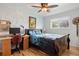 Bedroom featuring a bed, hardwood floor, ceiling fan, desk and blue accent wall at 4650 S Laredo St, Aurora, CO 80015