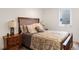 Bedroom featuring a wooden bed frame and side tables, neutral walls, and a large window at 4650 S Laredo St, Aurora, CO 80015