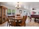 Traditional dining room featuring a wood table set, chandelier, hardwood floors, and built-in hutch at 4650 S Laredo St, Aurora, CO 80015
