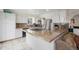 Well-lit kitchen with stainless steel appliances, island cooktop, and white cabinetry at 4650 S Laredo St, Aurora, CO 80015