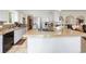 Spacious kitchen featuring a cooktop island, stainless appliances, and white cabinetry at 4650 S Laredo St, Aurora, CO 80015