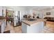 Open kitchen design with stainless steel appliances and view of dining and living areas at 4650 S Laredo St, Aurora, CO 80015