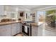 Kitchen featuring a cooktop island, stainless appliances, and access to outdoor patio at 4650 S Laredo St, Aurora, CO 80015