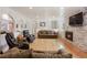 Bright living room featuring hardwood floors, a cozy fireplace, and a well-designed open-concept layout at 4650 S Laredo St, Aurora, CO 80015