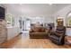 Inviting living room with an open kitchen concept, hardwood floors and stone fireplace feature at 4650 S Laredo St, Aurora, CO 80015