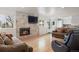 Cozy living room with a modern fireplace and hardwood floors perfect for relaxation and entertaining at 4650 S Laredo St, Aurora, CO 80015
