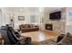 Spacious living room with a modern fireplace and hardwood floors create an inviting and open atmosphere at 4650 S Laredo St, Aurora, CO 80015