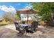 Outdoor patio area showcasing table and chairs beneath a large umbrella, perfect for enjoying the backyard at 4650 S Laredo St, Aurora, CO 80015