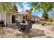 Inviting outdoor patio with flagstone and a patio table set with an umbrella, ideal for backyard entertaining at 4650 S Laredo St, Aurora, CO 80015