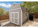 Backyard shed with double doors and a shingle roof, providing convenient outdoor storage at 4650 S Laredo St, Aurora, CO 80015