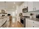 Modern kitchen with stainless steel appliances and granite counters at 19011 W 84Th Ave, Arvada, CO 80007