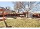 Backyard view includes green grass, patio with hammock, mature tree, and storage shed at 2823 N Lafayette St, Denver, CO 80205