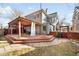 Backyard featuring a large deck area with a pergola, adjacent to a well-maintained lawn at 2823 N Lafayette St, Denver, CO 80205