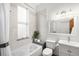 Bright bathroom features a tub, toilet, sink, and window offering natural light, creating a serene space at 2823 N Lafayette St, Denver, CO 80205