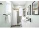 Bright bathroom with a shower, tub, white marble counters, and neutral gray tiling at 2823 N Lafayette St, Denver, CO 80205