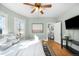 Light-filled bedroom features blue-green walls, hardwood floors, with an en-suite bathroom at 2823 N Lafayette St, Denver, CO 80205