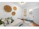 Cozy bedroom with natural light, decorative baskets, and an area rug creating a stylish and inviting space at 2823 N Lafayette St, Denver, CO 80205