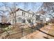 Beautiful gray two-story home with mature trees and a decorative black iron fence at 2823 N Lafayette St, Denver, CO 80205