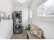 Laundry room features stacked washer and dryer, decorative pillows and wall art at 2823 N Lafayette St, Denver, CO 80205