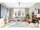 Sunlit living room featuring hardwood floors, decorative fireplace, and stylish furnishings at 2823 N Lafayette St, Denver, CO 80205