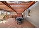 Outdoor deck with large dining table underneath a wood pergola with string lights at 2823 N Lafayette St, Denver, CO 80205