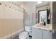Bathroom features modern fixtures, gray vanity, shower with striped curtain, and neutral color palette at 1287 Quitman St, Denver, CO 80204