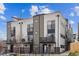 Modern townhome with mixed material facade, multiple balconies, and a rooftop patio, offering stylish urban living at 1287 Quitman St, Denver, CO 80204