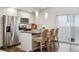Modern kitchen island with seating, stainless steel appliances, gray countertops, and pendant lighting at 1287 Quitman St, Denver, CO 80204