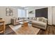 Spacious living room featuring a large sectional sofa, coffee table, area rug and ample natural light at 1287 Quitman St, Denver, CO 80204