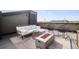 Stylish rooftop deck with comfortable seating, fire pit, patterned rug, and cityscape views at 1287 Quitman St, Denver, CO 80204